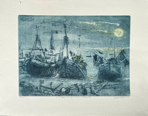 Contemporary aquatint etching in blue of boats on a beach at night with a moonlit sky