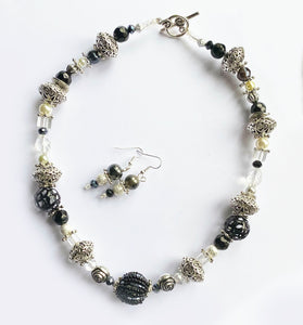 Artisan Necklace and earring set with main black bead at centre 