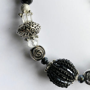 Artisan Necklace detail with big beads clear to black 