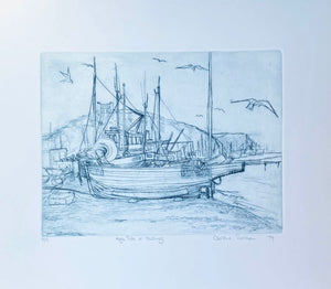 Drypoint Etching of boats pulled up on the shingle at Hastings with seagulls flying around  Turquoise blue  on cream background