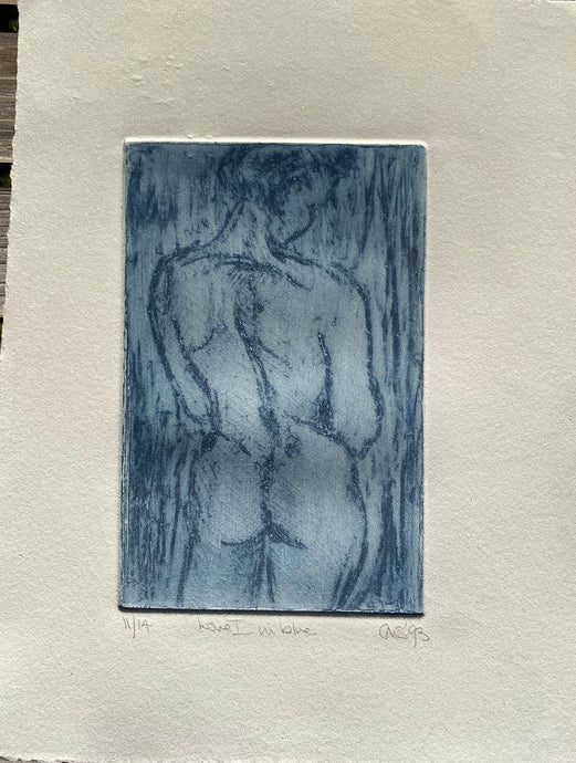 Etching of the back view of a female nude in blue ink on cream paper with hand torn edges.