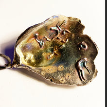 Silvered large oyster Shell on thong - inside colour