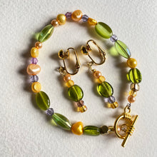 Spring bracelet set with 2 types od green beads, pearls in yellow and peach and a matching pair of guilt screw earrings 