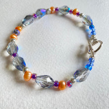 Blue teardrop Swarovski crystal bead and peach freshwater pearl bracelet and earring set by Caroline Salmon