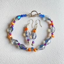 Blue teardrop Swarovski crystal bead and peach freshwater pearl bracelet and earring set by Caroline Salmon