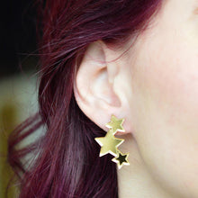 Triple Star Stud Earrings in Gold on ear